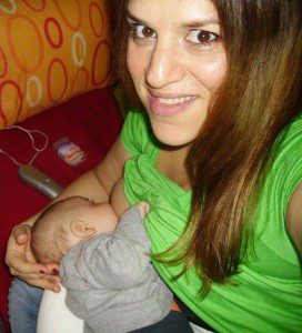 545px-Evi_Hassapides_Watson_breastfeeding_her_baby_boy.