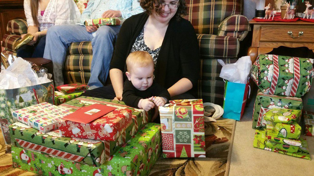 Baby surrounded by Christmas presents